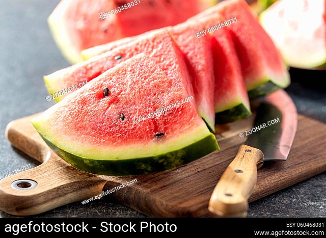 Red sliced watermelon. Pieces of red melon on cutting board