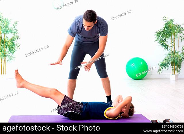The young father and his son doing exercises
