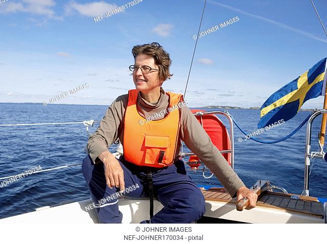 A smiling woman in a sailing boat