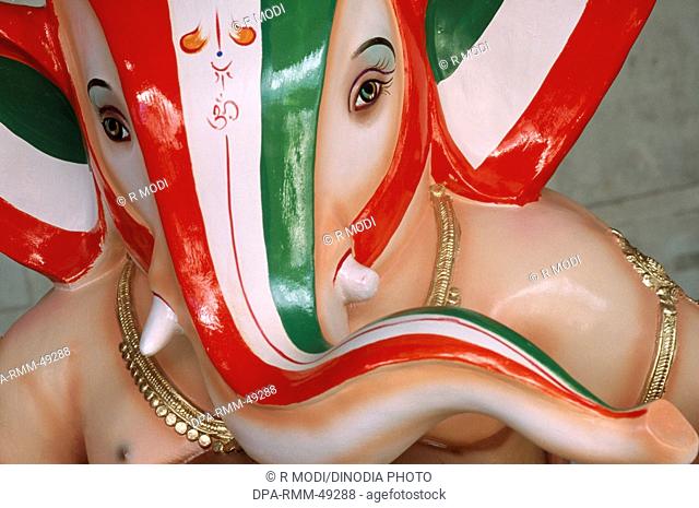 Ganesh ganpati Festival ; Procession of huge idol of Elephant headed God ; close ups of face ; Mumbai Bombay ; Maharashtra ; India