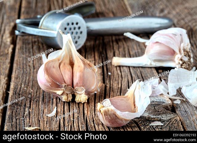 Head of dry garlic on rustic table, close up