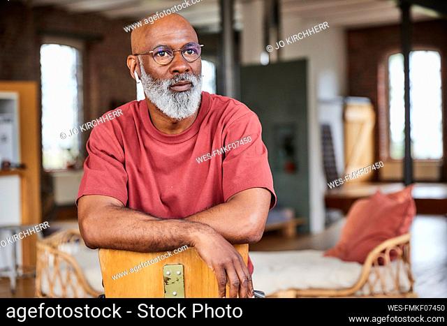 Thoughtful man with eyeglasses at home
