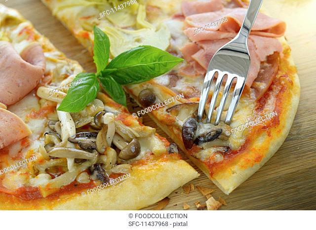 A pizza with turkey sausage, ham, mushrooms and artichokes