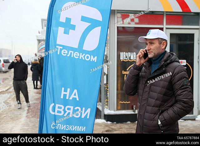 RUSSIA, LUGANSK - DECEMBER 15, 2023: A man speaks on the phone outside an outlet of +7Telecom, a new local service provider set to expand from the capital of...