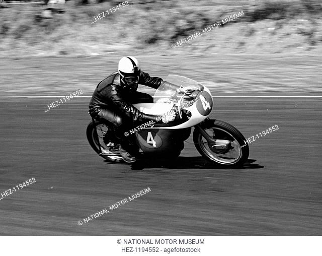 An Ariel 250 racing at Snetterton, Norfolk, 1962. The company was founded by James Starley and William Hillman in 1870 to make bicycles and the first patented...