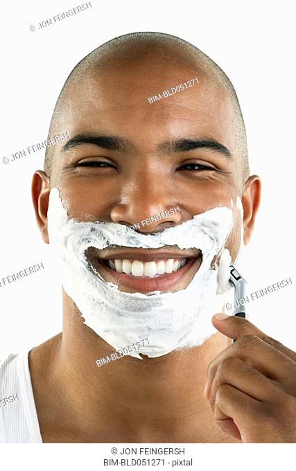 African man shaving face