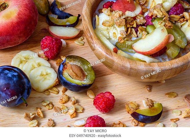Muesli with berries, fruits and milk - fit and healthy breakfast. Scattered ingredients and slices of fruits