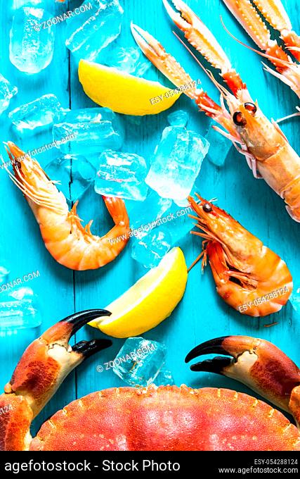 Fresh whole sea food from above with ice and lemon