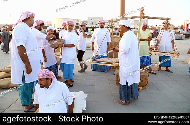 December 4, 2022, Doha, Qatar: Merchants of Arabian community repair fishing net At the sea's shore. Arabia is famous for its highly traditional