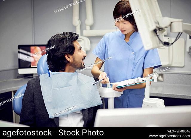Medical secretary preparing dental treatment for patient