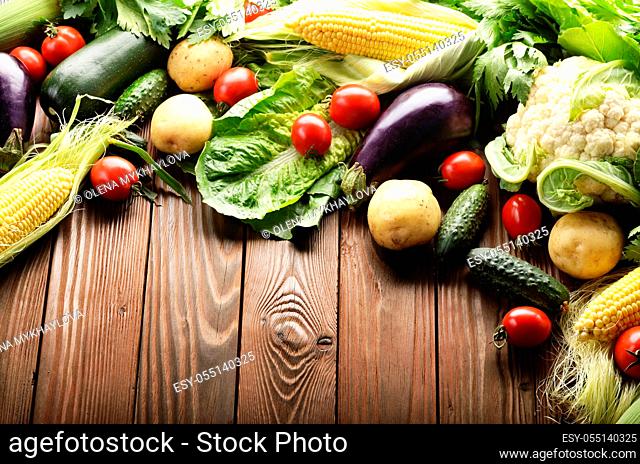 Fresh Organic Vegetable Food Ingredients on Wooden kitchen table background. Space for text