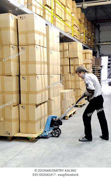 manual fork pallet truck operator in warehouse