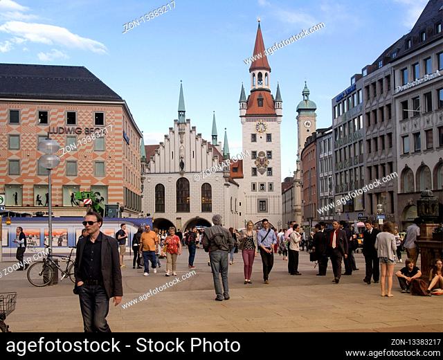 Munich, Germany - May 15, 2013: people crowds at central city square of Munich with famous Old City Hall - Alltes Rathaus building on background