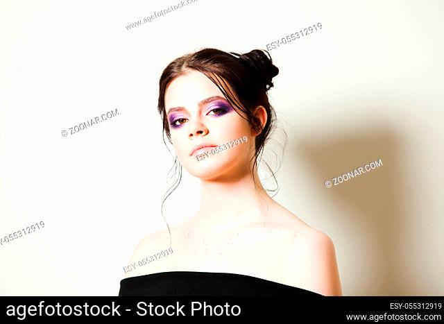 Portrait of a young beautiful brunette with a lovely fashion make-up on eyelashes