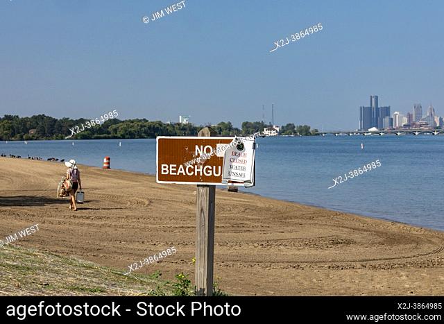 Detroit, Michigan USA - 28 August 2021 - As a heat wave sweeps across Michigan, a sign warns of unsafe water conditions at the Belle Isle Beach in the Detroit...