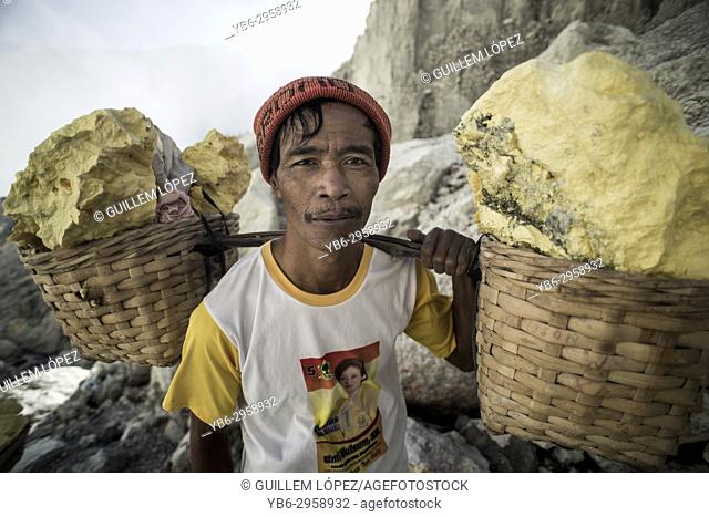 Portrait of one of the miner carrying sulfur rocks at the Kawah Ijen Volcano, East Java, Indonesia