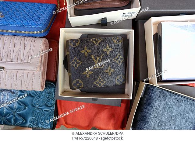 A counterfeit wallet with Louis Vuitton logo is offered for sale on a marketplace in Don Sao, Laos, 25 February 2015. Photo: Alexandra Schuler/dpa - NO WIRE...