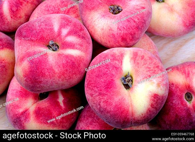 Close up view of a few fresh ripe saturn peach