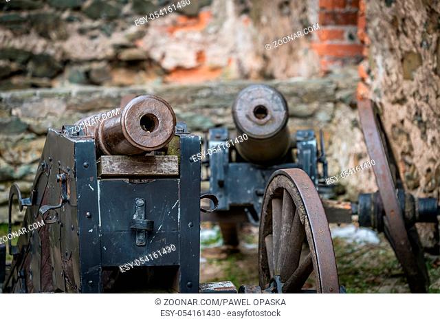 Old brass cannons in the courtyard of the ruins of the medieval Bolkow Castle in Lower Silesia, Poland