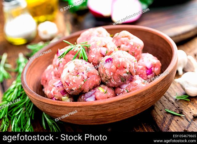 Raw meatballs close-up on wooden background