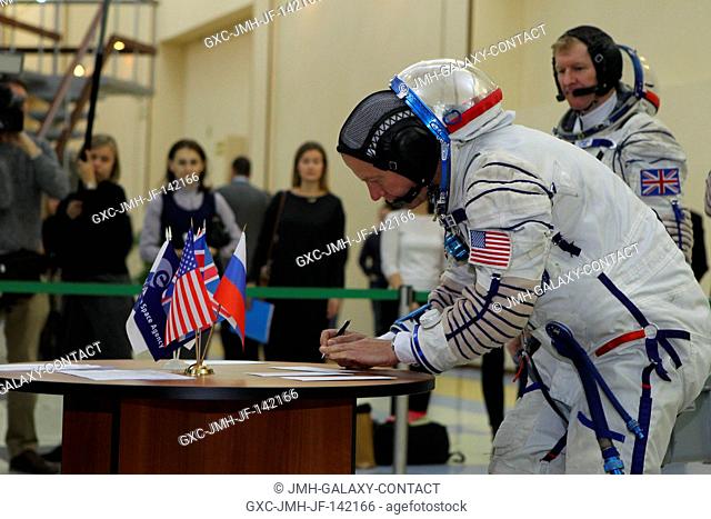 At the Gagarin Cosmonaut Training Center in Star City, Russia, Expedition 46-47 crewmember Tim Kopra of NASA signs in for his qualification exam Nov