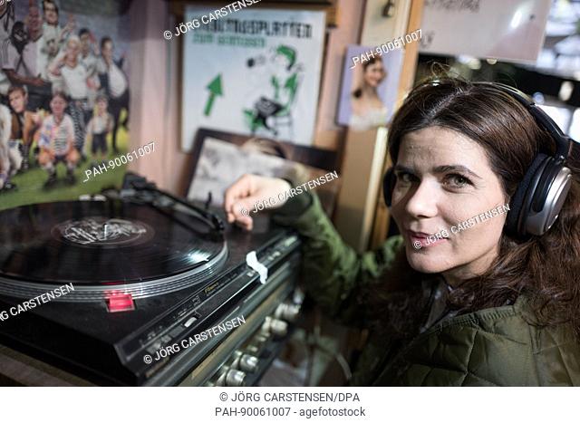 Dutch tourist Priscilla puts a record on in Vopo Records, a record shop in Berlin, Germany, 22 April 2017. Record Store Day, a celebration of vinyl records