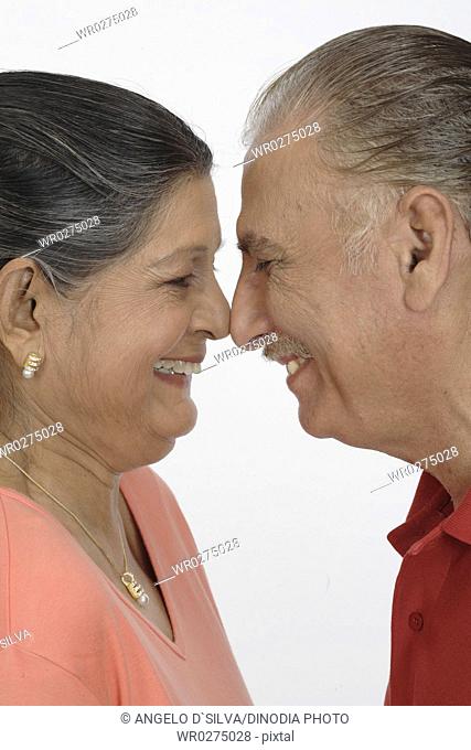 Old couple , old man and woman facing each other and touching noses and smiling MR 703B and 703