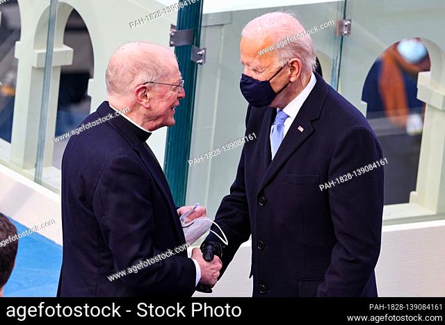 WASHINGTON, DC - JANUARY 20: U.S. President-elect Joe Biden greets Father Leo J. O’Donovan at Biden's inauguration on the West Front of the U.S