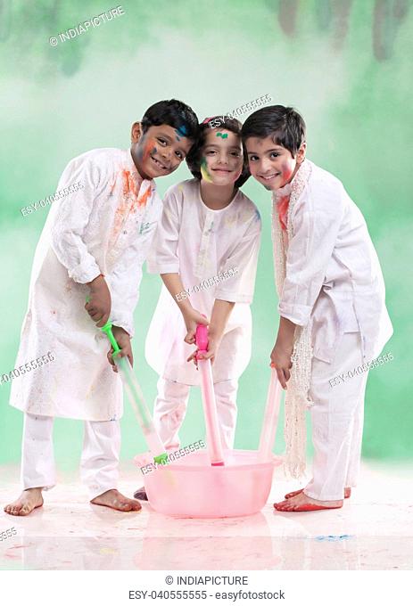 Children filling their pichkaris with water