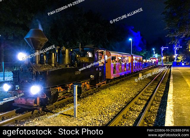 05 August 2022, Brandenburg, Cottbus: A train pulls into a station during the so-called light rides of the Cottbus park railroad