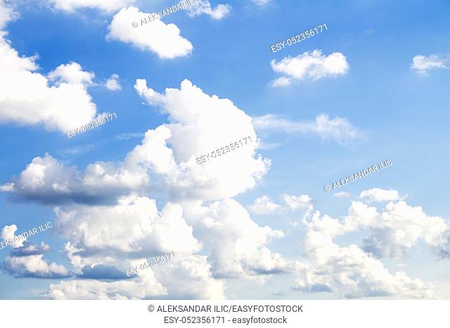 Clear blue sky with White Fluffy clouds as background