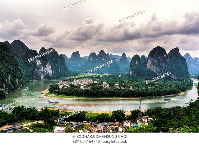 The view of xingping and li river from a nearby mountain in xingping, guangxi, china. Taken during cloudy summer day
