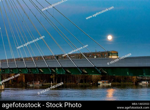 Vienna, full moon above subway U2 bridge Donaustadtbrücke above river Donau (Danube) in 02. Leopoldstadt, Austria