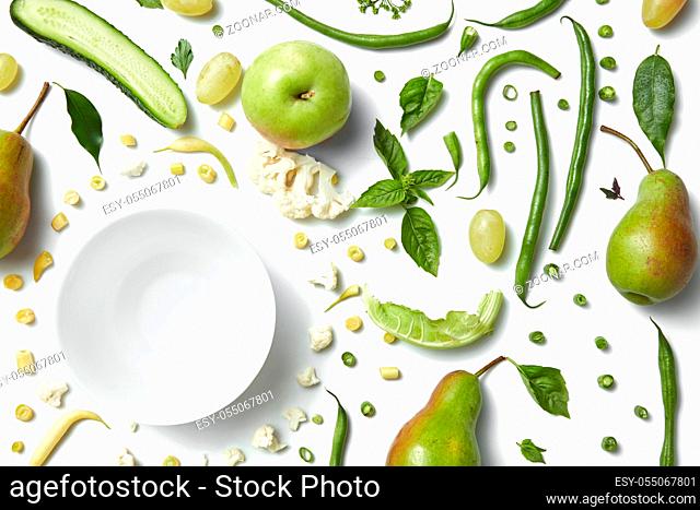 Close up of green vegetables and fruits isolated on white. Healthy eating and food for vegans