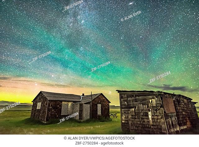 The Pleiades rising behind the rustic cabins and outbuildings of the historic Larson Ranch in Grasslands National Park, Saskatchewan