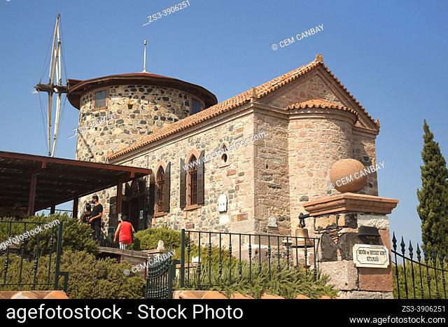Tourists visiting the restored windmill which is now converted in to the Sevim and Necdet City Library at the town center of Cunda or so-called Alibey...