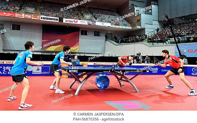 Germany's Timo Boll (2.f.r) and his doubles partner Patrick Franziska (r) against Japan's Kenta Matsudaira and Koki Niwa in the semi final of the German Open in...