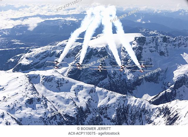 Canada's Tudor flying demonstration team, the Snowbirds, flies over mountains in strathcona Park