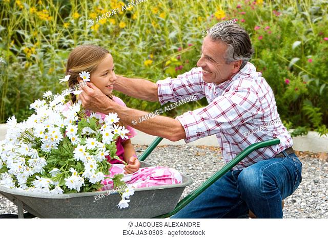 Putting flower hair Stock Photos and Images | agefotostock