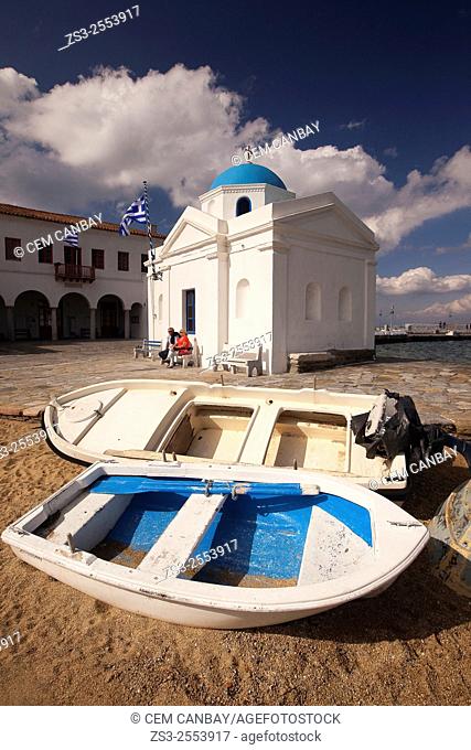 Fishing boats at the beach with a blue domed church at the background in town center, Mykonos, Cyclades Islands, Greek Islands, Greece, Europe