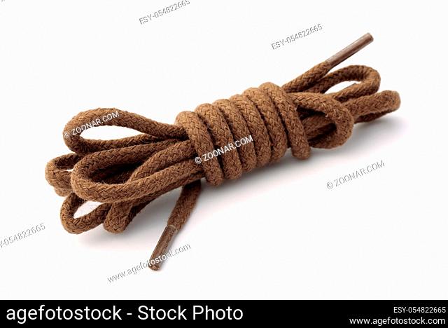 Rolled cotton brown shoelaces isolated om white