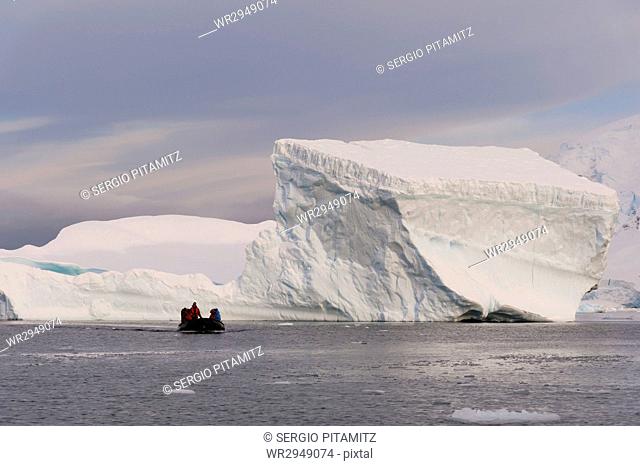 Tourists exploring Skontorp Cove in inflatable boat, Paradise Bay, Antarctica, Polar Regions