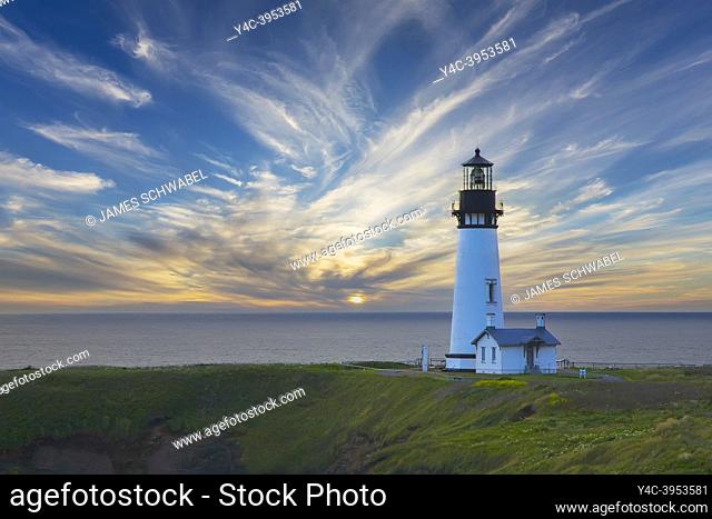 Sunset behind Yaquina Head Lighthouse on the Pacific Ocean coast of Oregon near Newport Oregon