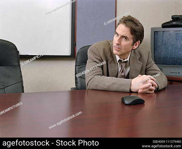 Businessman sitting at conference table