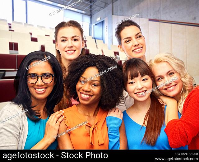 group of happy student women hugging at university