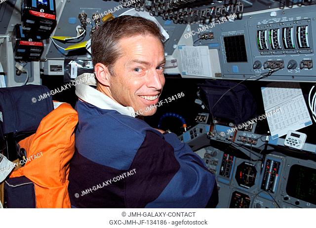 Astronaut James D. Wetherbee, STS-113 mission commander, occupies the commander's station on the forward flight deck of the Space Shuttle Endeavour during...