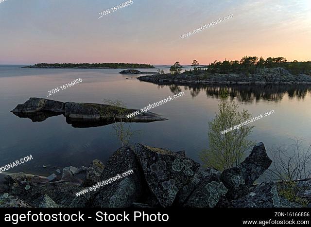 Small islands in the Ladoga skerries, Karelia, Russia. Evening, shortly before sunset. The beginning of June