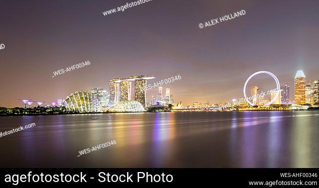 Singapore, Long exposure of Marina Bay at night with Marina Bay Sands hotel and Singapore Flyer in background