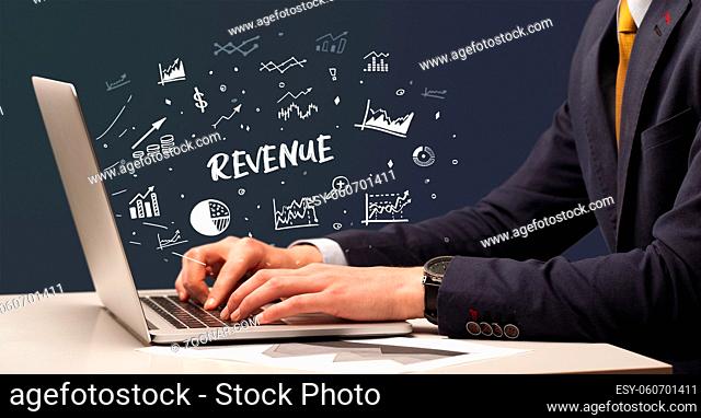 Businessman working on laptop with REVENUE inscription, modern business concept