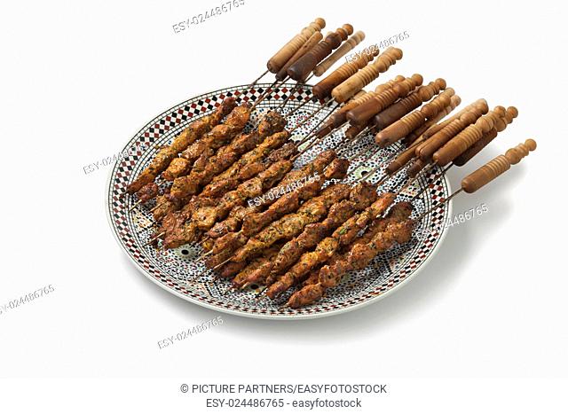 Dish with Moroccan lamb kebab on white background